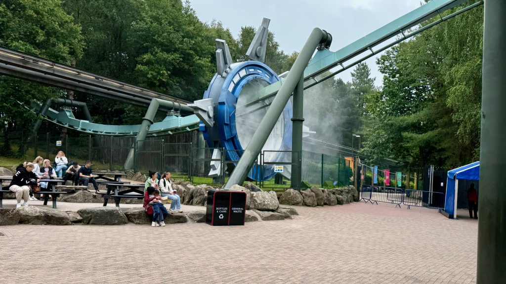 Galactica ride track through a circle emitting mist. 