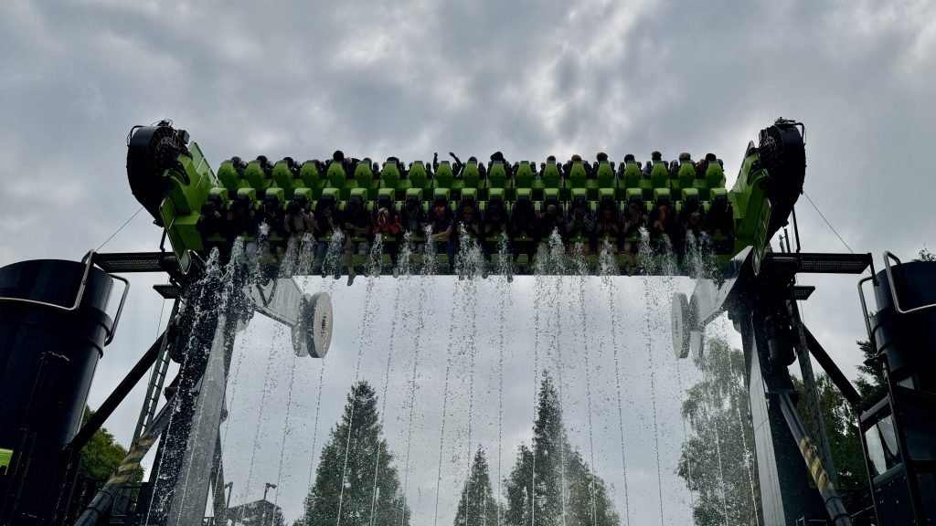 Toxicator ride with jets of water splashing riders suspended in-air. 